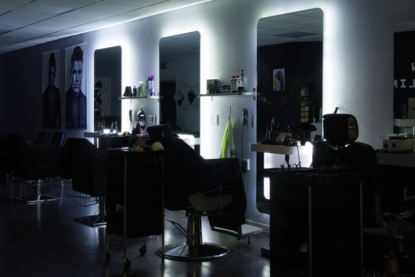 Barber shop at night with backlit mirrors